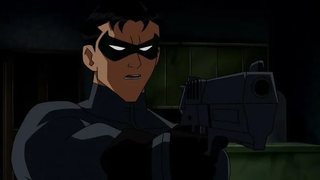 Frame de animação do personagem Robin (sidekick do Batman) vestindo seu traje escuro e máscara verde, segurando e apontando uma pistola com uma expressão tensa, em um ambiente escuro.